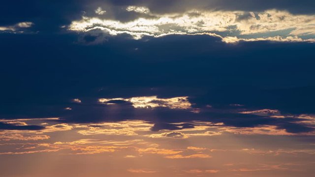 Timelapse of Colorful Sunset with the Sun shining through the clouds