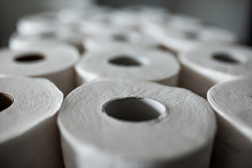 Toilet paper bunched up together on a counter in a home