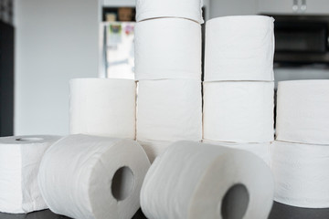Toilet paper bunched up together on a counter in a home
