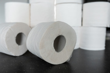 Toilet paper bunched up together on a counter in a home