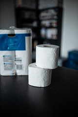 Toilet paper bunched up together on a counter in a home