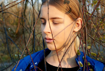 Spring teenage girl portrait near willow
