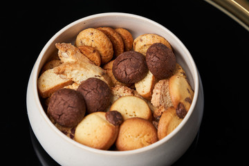 Sweet cookie snack and cappuccino coffee cup on table, close-up