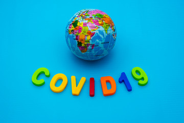 Globe and text COVID 19 on a blue background. Coronavirus / Corona virus concept. The spread of corona virus in the World