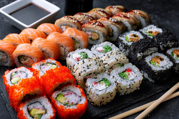 Sushi set, on a black background, five types of rolls