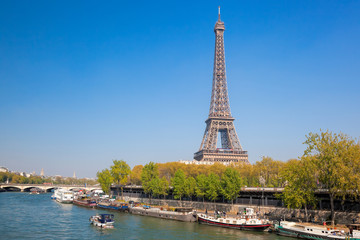 Fototapeta na wymiar Paris with Eiffel Tower against boats during spring time in France