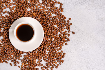 Coffee in a cup with coffee grains