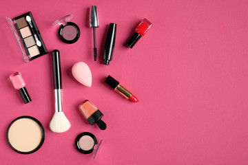 Makeup cosmetic products on pink background. Top view, flat lay