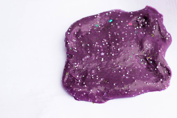 Children's creativity and motor development. Slime purple close-up on a white background in the form of a BLOB.