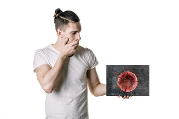 young man holds a picture of bacteria. The danger of coronavirus. horizontal frame - Powered by Adobe