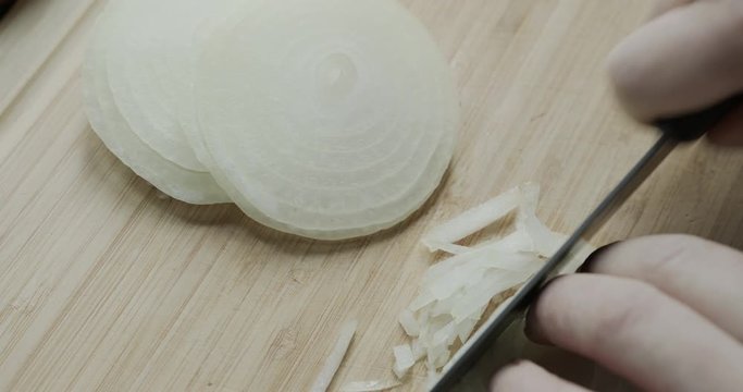 Cutting an onion on a chopping board