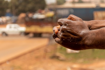 african man washing his hands outdoor
