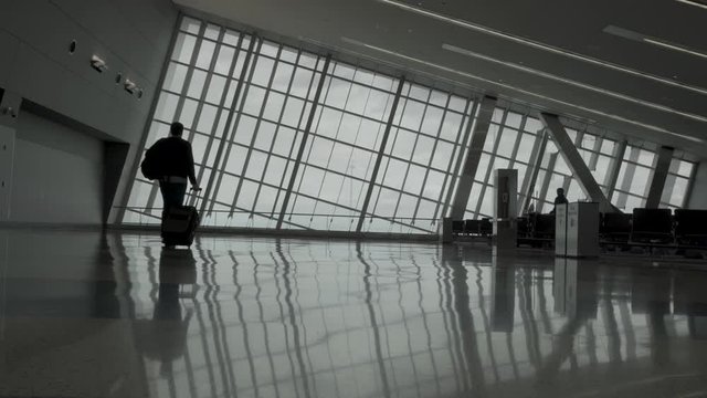 Man is walking in an empty airport 4K