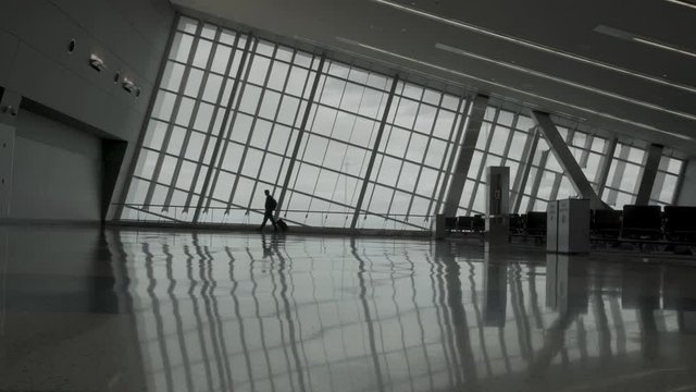 Man is walking in an empty airport 4K