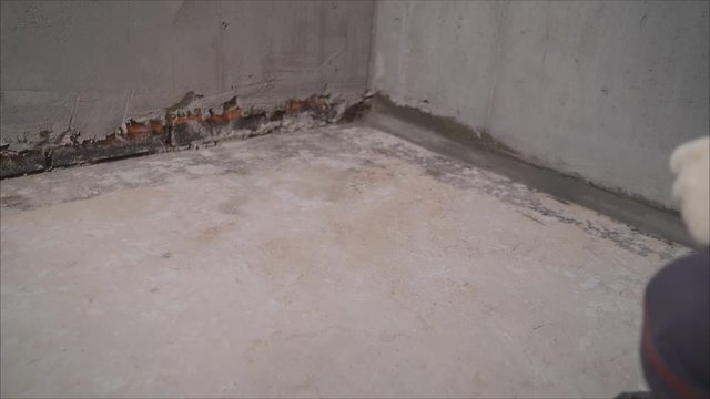 Worker vacuuming concrete floor. construction cleaning service sleeve anchor bolt . dust removal with vacuum cleaner