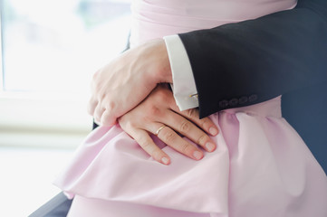 Wedding couple holding hands and hugging. Love couple. Romantic feelings at sunset. Elegant bride. Newlyweds embracing at wedding day