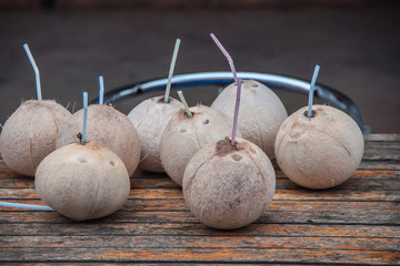 Guilin, China - May 10, 2010: Downtown. Closeup of 8 beige peeled coconuts each with plastic...