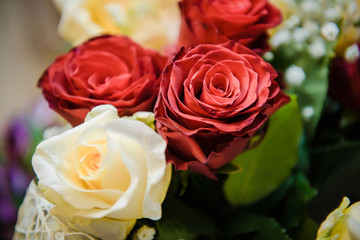 Naklejka premium Fresh, lush bouquet of colorful flowers for present close-up photo. Wedding bouquet, red and yellow roses