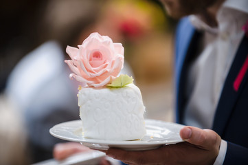Luxurious pink wedding cake with flowers. Birthday, Valentine's day cake. Cupcakes with pink roses. Wooden background