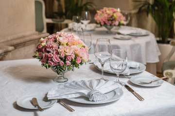 Colorful wedding bouquet on a restaurant served table. Bridal bouquet. Luxury royal restaurant. Valentine's day, birthday, dating or mother's day decoration