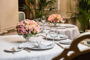 Colorful wedding bouquet on a restaurant served table. Bridal bouquet. Luxury royal restaurant. Valentine's day, birthday, dating or mother's day decoration