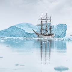 Fototapeta na wymiar sailing Expedition ship in antarctica surrounded by ice 