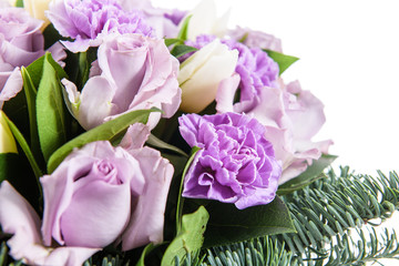 Obraz premium Fresh, lush bouquet of colorful flowers for present isolated on white background. Wedding winter bouquet of purple and white roses and freesia flowers. Christmas bouquet