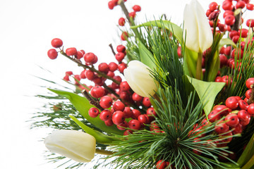 Christmas bouquet. Fresh, lush bouquet of colorful flowers for present on white background. Wedding bouquet of white tulips, red berries and freesia flowers