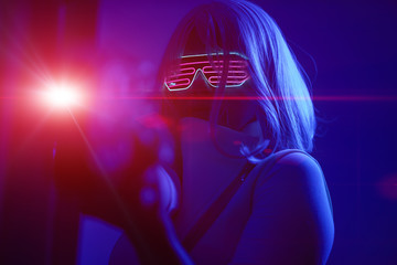 Girl with blaster in the futuristic battle. Concept virtual reality, cyber game.