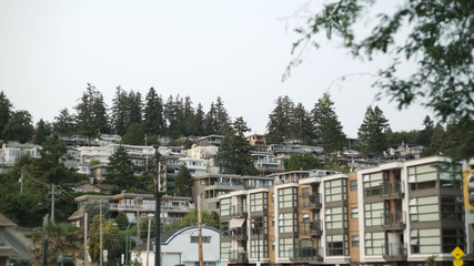 Fototapeta na wymiar Apartment buildings and street life in White Rock British Columbia