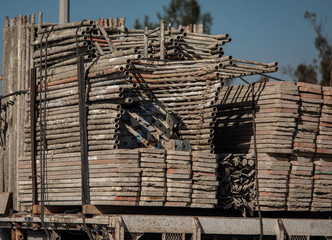 Scaffolding materials including metal frame and planks loaded on flatbed truck