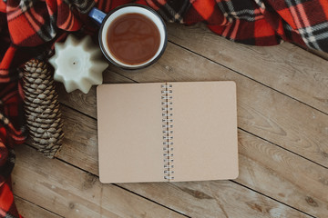 Open vintage books with copy space; overhead view. Flat lay winter and autumn cozy vintage background with copy space. The cup of tea or coffee on wooden table. Christmas atmosphere.