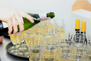 Pouring champagne in stylish glasses