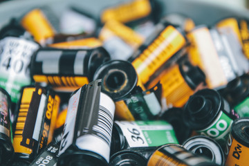 Fototapeta premium BANGKOK, THAILAND - MARCH 20, 2020: Some various brand of used film rolls in wood box, seems to be obsoleted since digital camera has come into market but still be favorite in some group.
