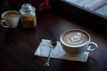 Hot coffee cup on a wooden table. / selective focus