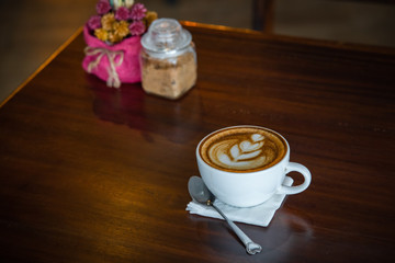 Cup of coffee on old wooden desk. / selective focus