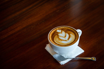 Hot coffee cup on a wooden table.
