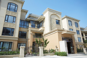 Townhouses under blue sky and white clouds