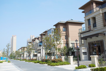 Townhouses under blue sky and white clouds