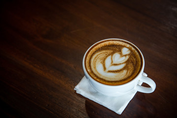 Hot coffee cup on a wooden table.