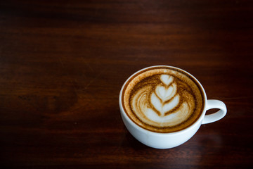Hot coffee cup on a wooden table.