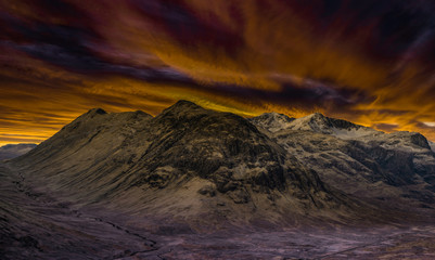 fire red sky above glencoe mountains, highlands, scotland.