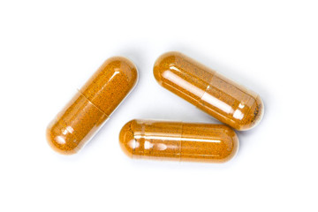 Turmeric capsule isolated on white background. 