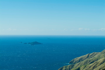 Fototapeta na wymiar Blue islands in the ocean. French Pass, New Zealand. Top view to blue horizon, ocean view and small rocky islands