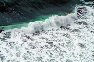 Fototapeta na wymiar Dramatic seaview, top view to the waves