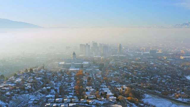 Birds eye view of heavy inversion in Salt Lake City on snowy winter morning