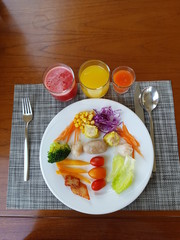 Top view of sausage, dumplings, salads and fresh juices wooden background copy space.  Nutritious food and drink concept.