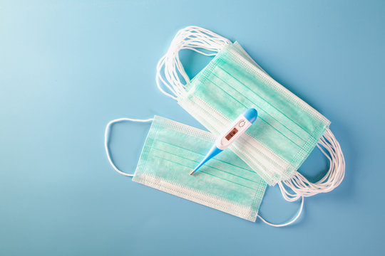 Mask with rubber ear straps. Typical 3-ply surgical mask to cover the mouth and nose. Procedure mask from bacteria. Protection concept.