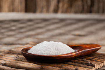 Baking soda on wooden background, space for text