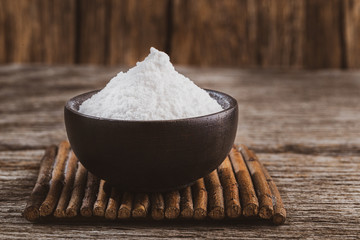 Baking soda on wooden background, space for text